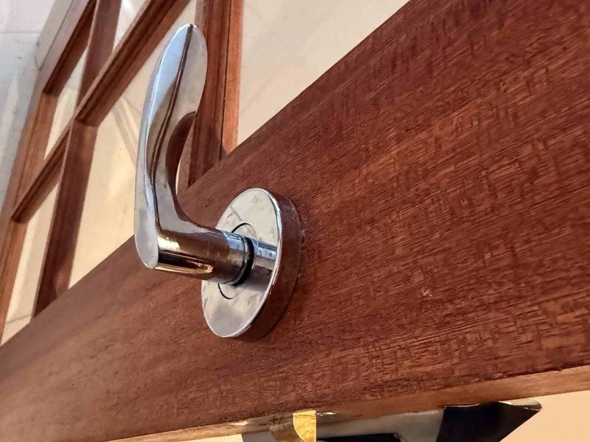 Chrome handle on a timber door