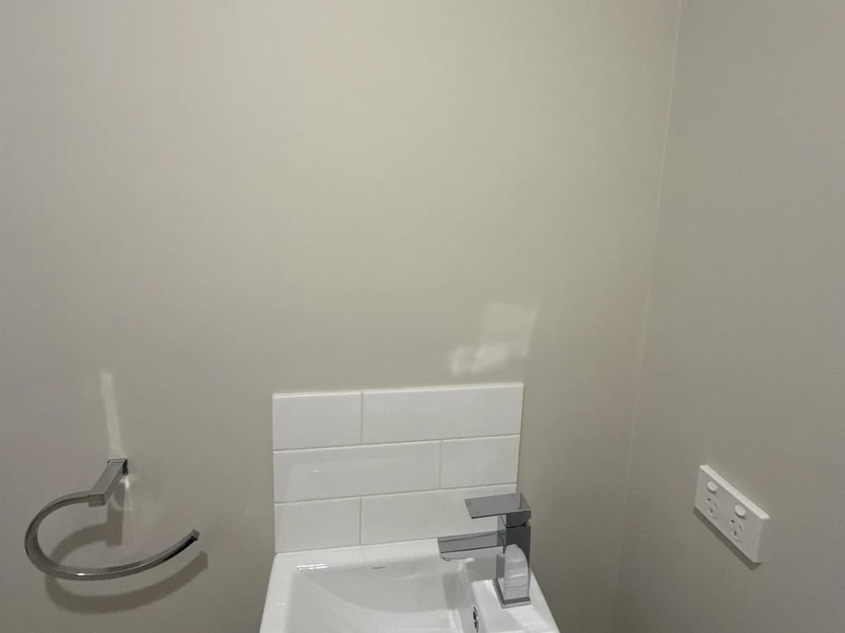 Handbasin with tiled splashback