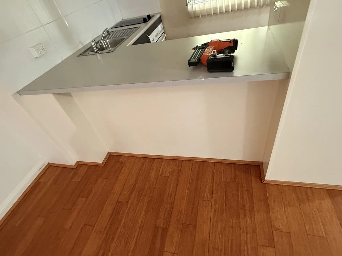 Timber floor and skirting around a kitchen bench